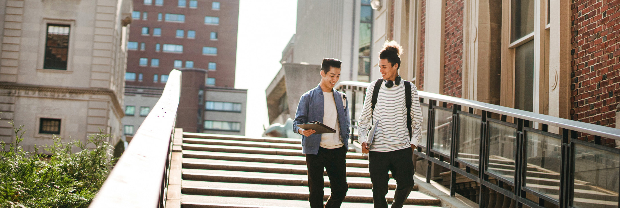 Two students walking down stairs on campus
