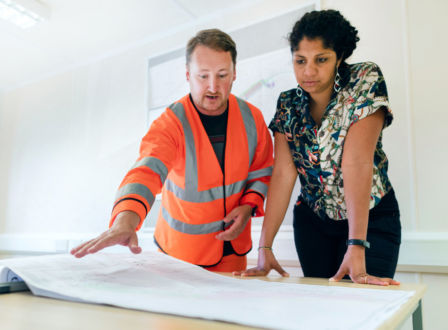 Foreman pointing up in the air with co-op student beside him