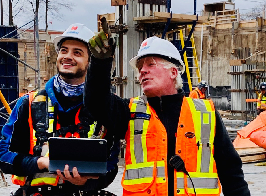 Foreman pointing up in the air with co-op student beside him